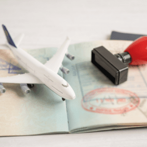 An airplane and a passport with an immigration stamp.